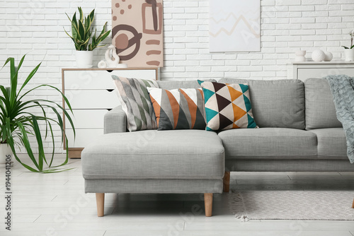Grey couch with stylish cus...