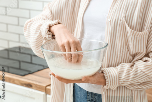 Woman rinsing rice in glass...