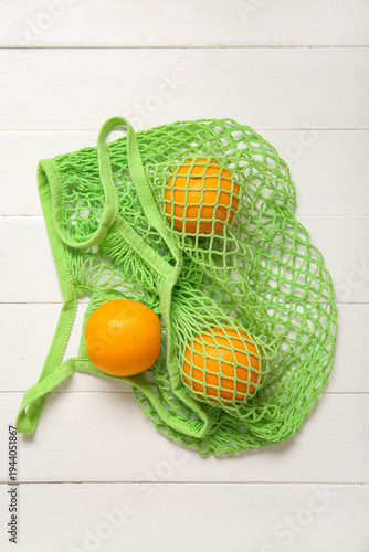 Mesh bag with fresh oranges...