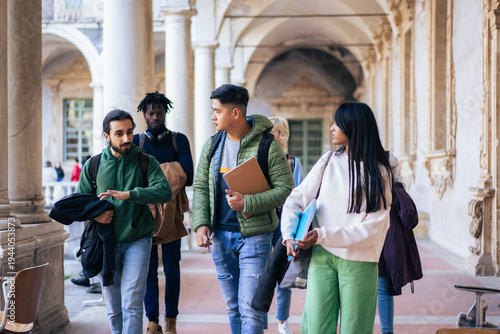 Diverse Group of University Students Walking and Talking in Historic Campus Corridor