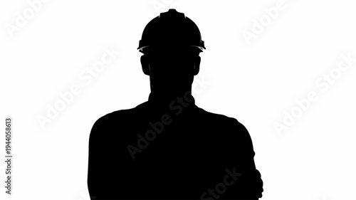 Silhouette of a factory worker wearing a hard hat against a white background industrial setting