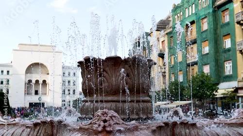 Large ornate stone fountain with jets spraying in a Timisoara square, Romania