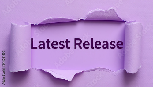 A purple background with a torn paper revealing the words latest release