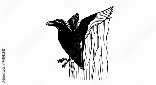 Black bird with outstretched wings perched on striped wooden surface