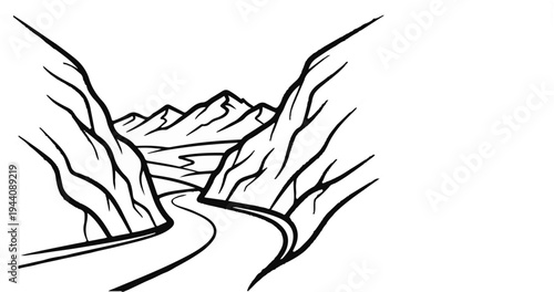 A winding road cuts through a dramatic mountain pass with distant peaks