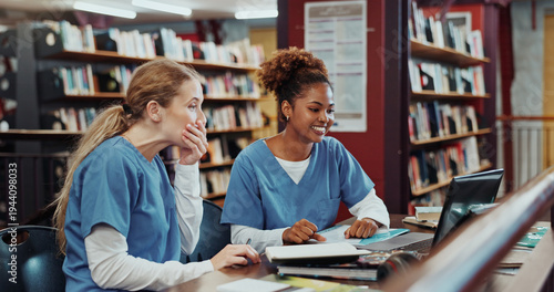 Women, medical students and happy with laptop at library for test results, solution and project at campus. Girl, healthcare scholarship and computer with smile, discussion and feedback at university
