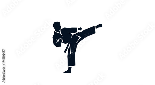 Man in karate uniform kicking high.