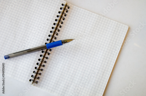 Cuadro en lienzo Open Notebook with Blue Pen on White Surface