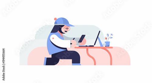 Person in a cap using laptop and phone at a table with a plant