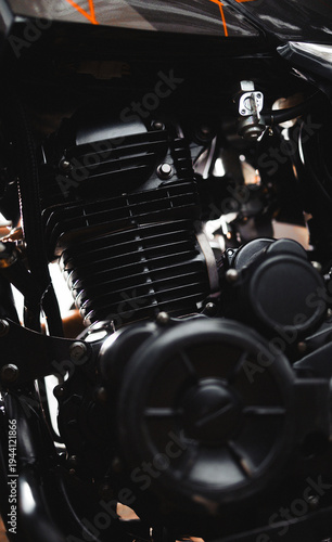 Close-up of a black air-cooled motorcycle engine.