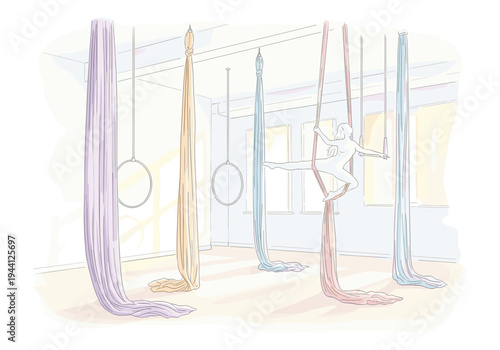 Aerial silks performer gracefully poses mid-air in a bright studio with colorful fabrics