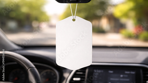 Blank car air freshener mockup hanging on rearview mirror.