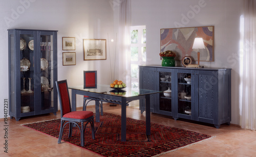 Vászonkép Single shot photo of a room with a rattan table, chairs and display cabinet