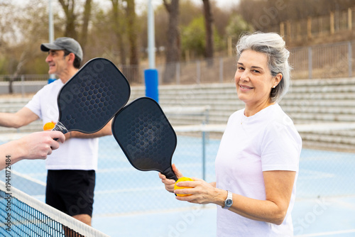 Senior couple enjoying pickleball on outdoor court