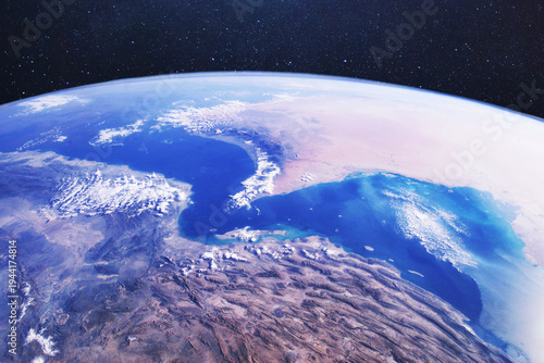 satellite view of the Strait of Hormuz and Iran from space. Conceptual for geopolitical conflict, oil supply blockade, military tension in the Middle East, and global energy crisis. Earth from space