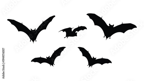 A group of five black bats flying in formation against a white background, creating a spooky yet fascinating scene of nocturnal creatures in flight