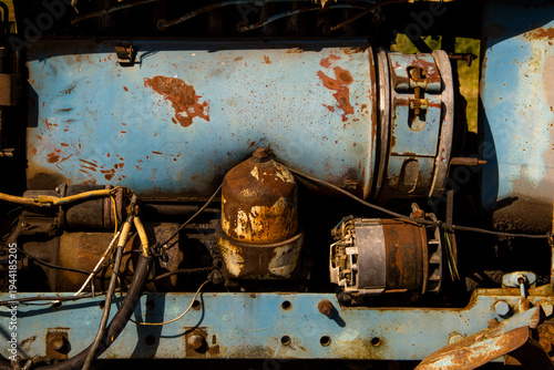 Old rusty tractor engine close-up. Industrial background. Selective focus.