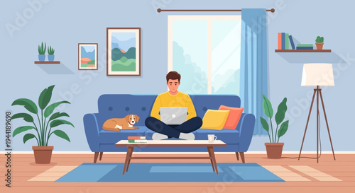 Man sitting on blue couch with laptop.