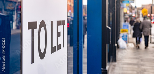 Shop To Let sign on high street window