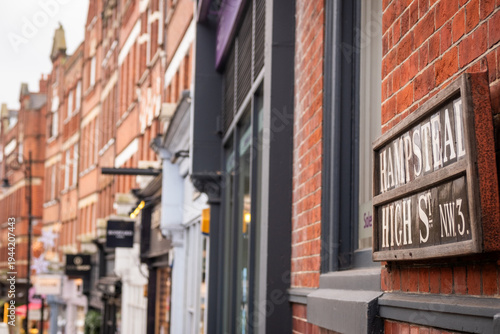 LONDON - 15 DECEMBER 2025: Hampstead High Street NW3 – Classic Street Sign on Brick Wall