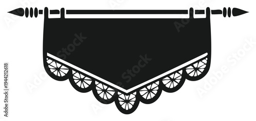 Black decorative textile hanging on a rod with ornate trim detail