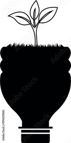 A young plant grows from a recycled plastic bottle symbolizing sustainability