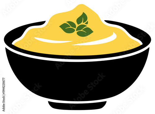 Yellow cream or dip in black bowl garnished with green herb sprig