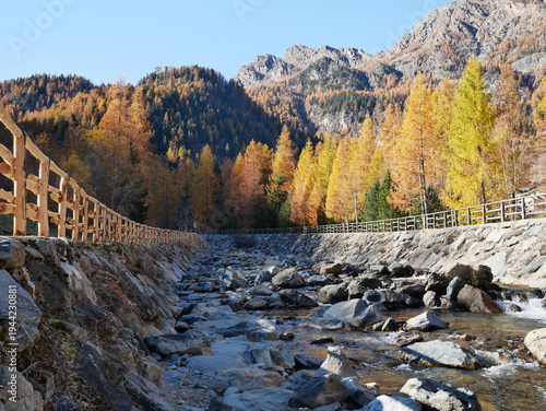Autumn in the Alps. Chardonney, a hamlet of Champorcher, Aosta Valley, Alps, Italy. Along the river bottom.
