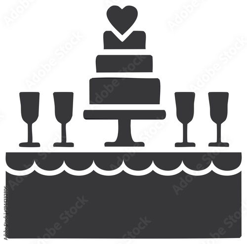 Elegant tiered wedding cake with heart topper and champagne flutes on decorated table for celebration