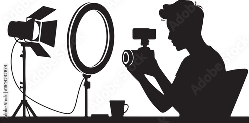 Silhouette of person filming with camera and lighting