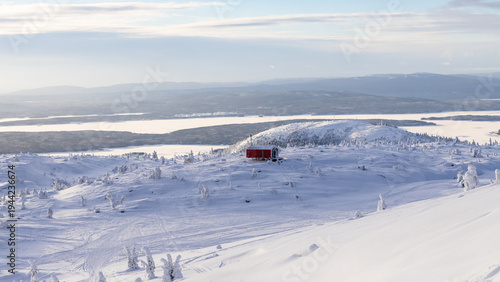 aerial view of snowy hill with mobile house balok