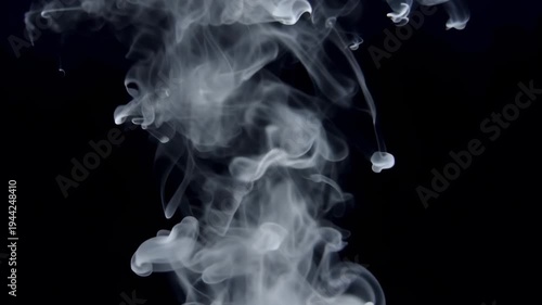 Ethereal white smoke or ink gracefully descending through a deep black void. The fluid, wispy tendrils swirl and bloom into delicate, cloud-like patterns, creating a hypnotic and abstract visual.