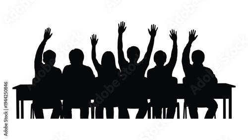 A group of students sitting at a desk with their hands raised in a classroom setting, possibly answering questions or participating in a discussion.