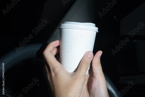 Two-Handed Grip on Hot Coffee Cup in Vehicle