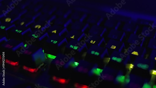 PC RGB Keyboard is Glowing Neon Colors. Modern Backlit Keyboard With Pulsating RGB Colour Light. Cyber Sport Illuminated Mechanical Gaming Keyboard. Gaming Keyboard With Rainbow of Colors Letters.