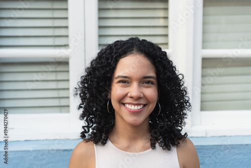 Vászonkép Young woman smiling with natural curly hair