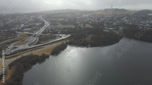 Wallpaper Mural Aerial drone footage showing a suburban area during gloomy midday conditions. The scene features residential houses, streets, and surrounding infrastructure under overcast skies and diffused daylight, Torontodigital.ca
