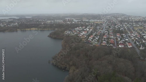 Wallpaper Mural Aerial drone footage showing a suburban area during gloomy midday conditions. The scene features residential houses, streets, and surrounding infrastructure under overcast skies and diffused daylight, Torontodigital.ca
