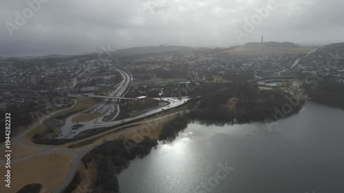 Wallpaper Mural Aerial drone footage showing a suburban area during gloomy midday conditions. The scene features residential houses, streets, and surrounding infrastructure under overcast skies and diffused daylight, Torontodigital.ca