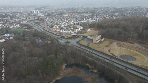 Wallpaper Mural Aerial drone footage showing a suburban area during gloomy midday conditions. The scene features residential houses, streets, and surrounding infrastructure under overcast skies and diffused daylight, Torontodigital.ca