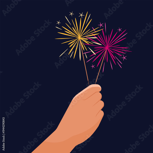 Hand holding lit sparklers for celebrations
