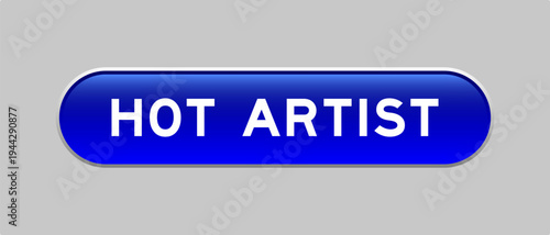 Blue color capsule shape button with word hot artist on gray background