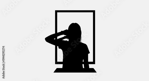 Silhouette of a woman looking in a mirror, adjusting her hair