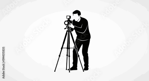 Man operating a camera on tripod.