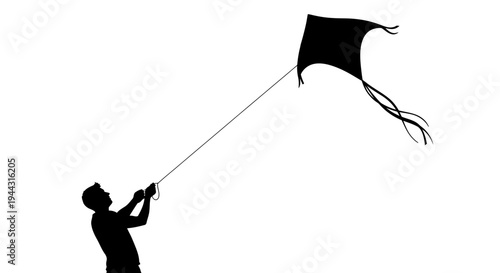 Silhouette of a boy flying kite.