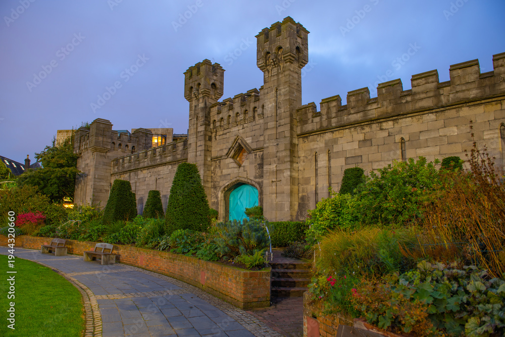 Obraz premium Coach House at sunrise with blue hour twilight. This building is at Dubh Linn Garden in Dublin Castle at the historic city centre of Dublin, Ireland. 