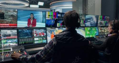 Backstage TV Station Production Control Room Operators Manage a Live News Broadcast, Switching Studio Feeds, Monitoring Industrial, Business News  Coordinating Channel Output Across Monitors