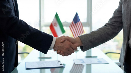 Businessmen shake hands in office with Iranian and American flags on table, concept of peace agreements, diplomacy, economic sanctions, resource control, Middle East conflict, space for text