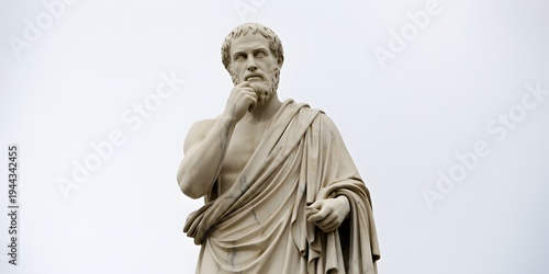 A statue of a philosopher in a contemplative pose against a gray background
