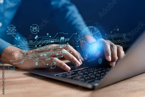 Hands typing on a laptop with a glowing digital interface showing global network and data analytics